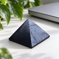 40 mm polished shungite pyramid on a desk