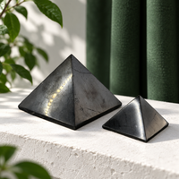 Two polished shungite pyramids, 40 mm and 70 mm, side by side
