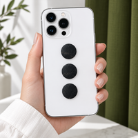 Phone held in hand with three shungite stickers on the back