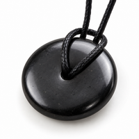 Small shungite donut pendant with a knotted black cord