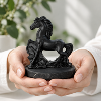 Shungite horse figurine held in two hands