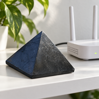 Shungite pyramid placed beside a Wi-Fi router