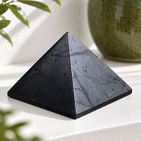 40 mm polished shungite pyramid on a living-room shelf