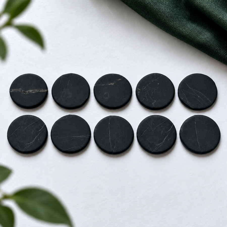 Ten 20 mm shungite phone stickers laid out in rows