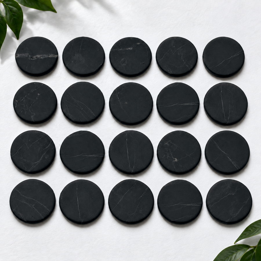Twenty 20 mm shungite phone stickers laid out in rows