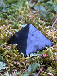 40 mm shungite pyramid on moss and grass