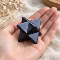 Shungite merkaba star tetrahedron held in a hand