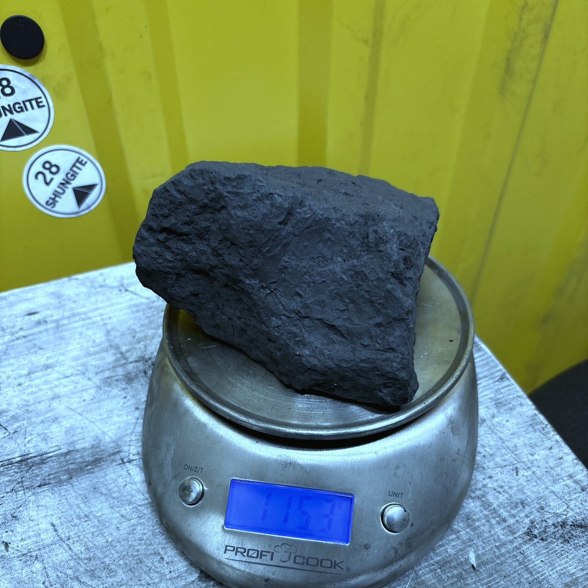 Raw shungite specimen 020, 1153 g, on the scale showing its weight